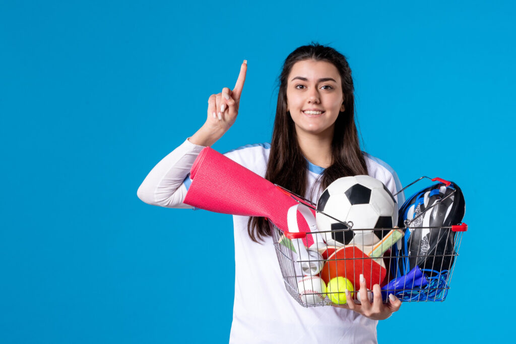 front-view-young-female-after-sport-shopping-blue-wall