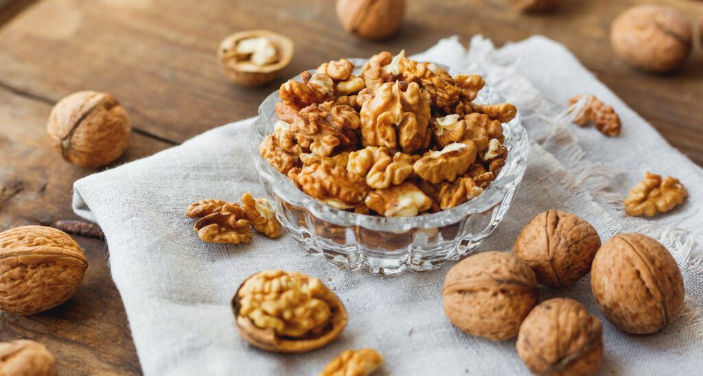 glass-bowl-with-walnuts-on-rustic-homespun-napkin-royalty-free-image-1640002718
