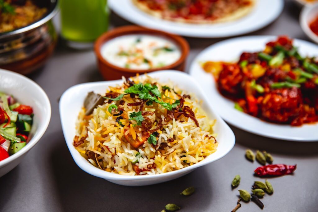side-view-rice-garnish-with-fried-onion-carrot-greens-chili-pepper-table (1) (1)