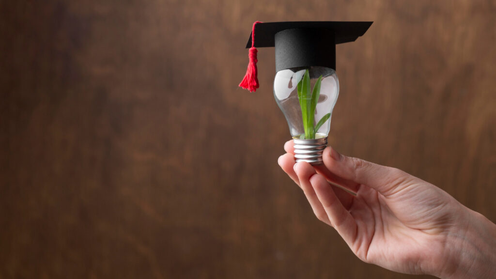 close-up-hand-holding-light-bulb-with-plant